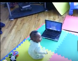 Baby playing on a laptop